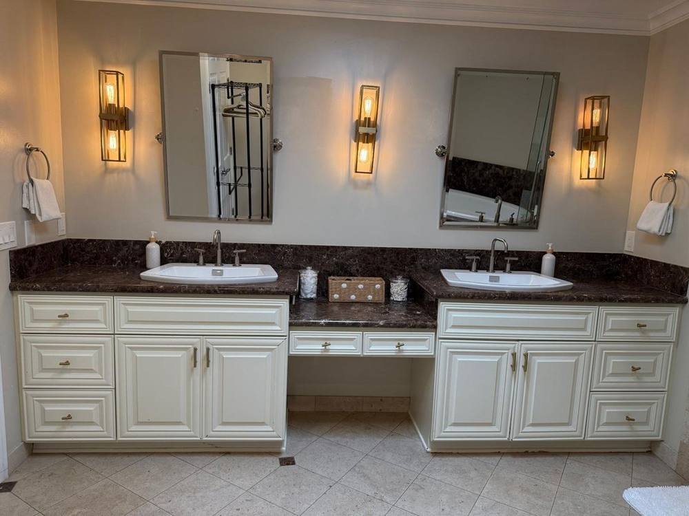 Sparkling sanitized Airbnb bathroom with streak-free glass and gleaming marble fixtures