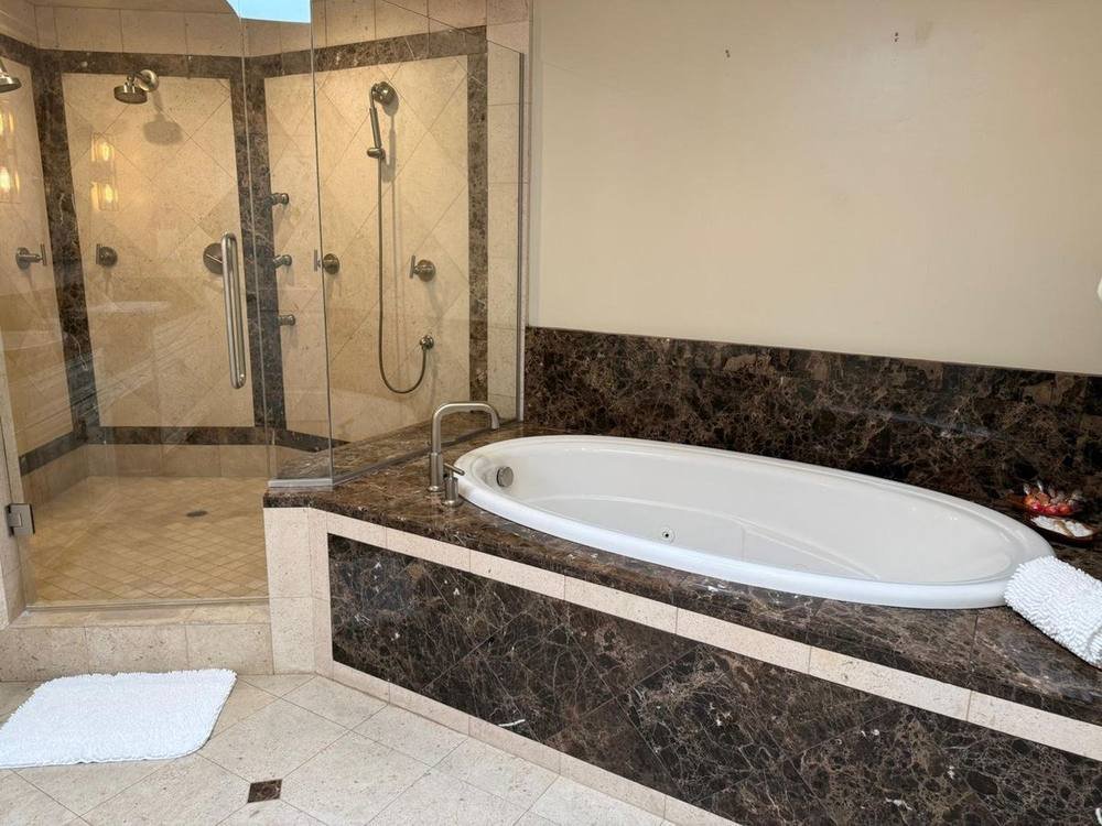 Decorative 5-star spa folded towels and restocked guest toiletries in a vacation rental bathroom